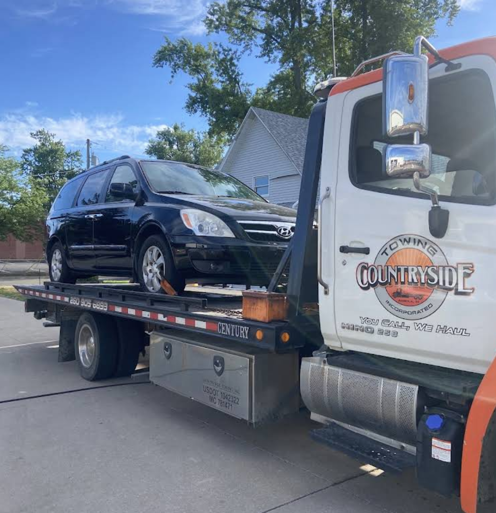 Countryside Towing flatbed truck loaded with a vehicle in Angola, Indiana